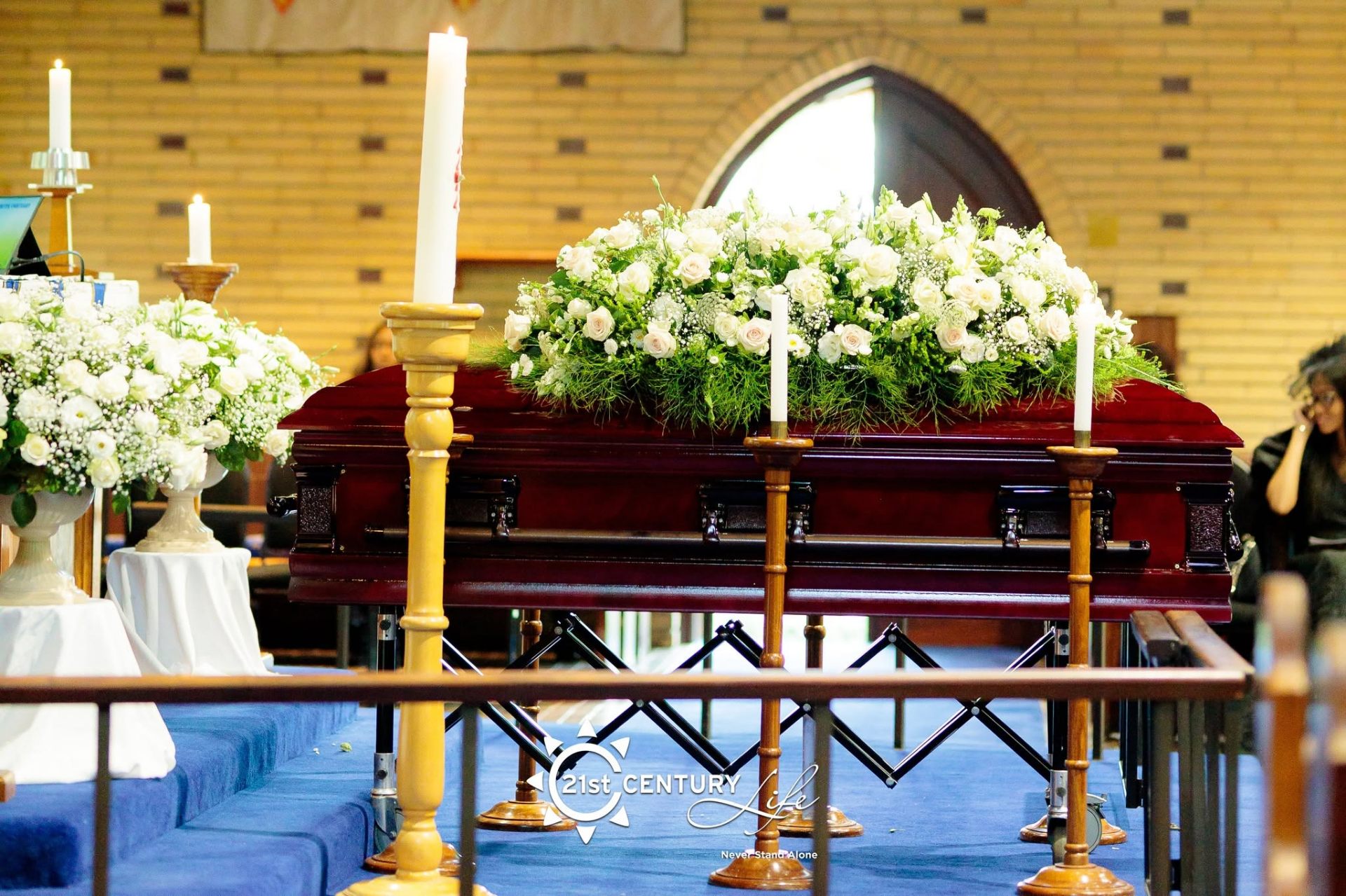 Casket with white floral spray